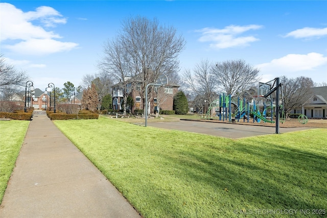 view of basketball court featuring a yard and a playground