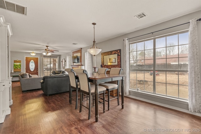 dining area featuring dark hardwood / wood-style floors and ceiling fan