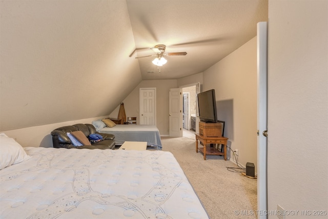 bedroom with ceiling fan, vaulted ceiling, light carpet, and a textured ceiling