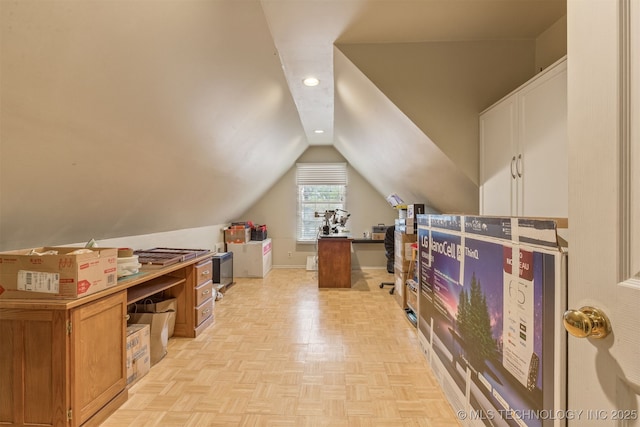 bonus room with light parquet flooring and vaulted ceiling