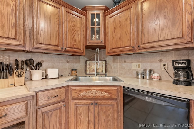 kitchen featuring dishwasher, sink, and decorative backsplash