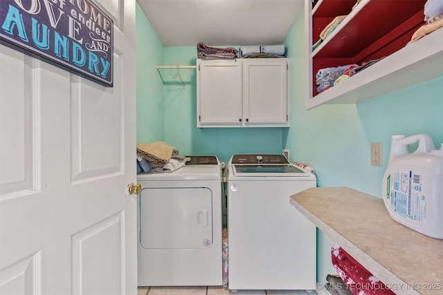 washroom featuring cabinets and washer and dryer