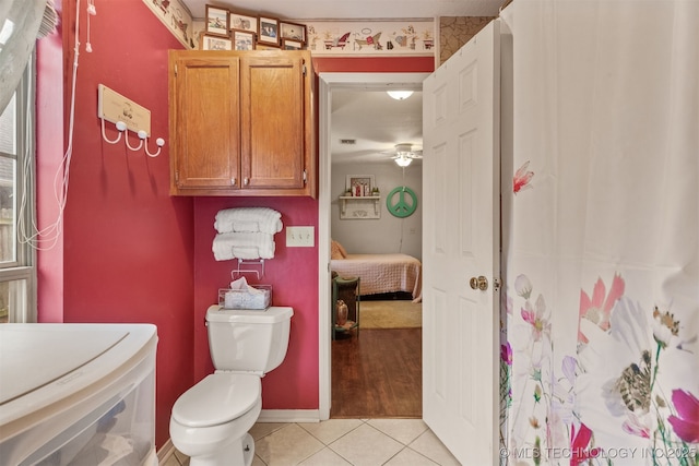 bathroom with ceiling fan, tile patterned floors, and toilet