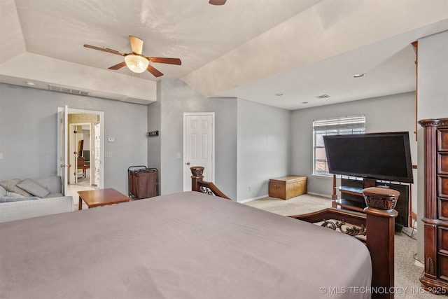 bedroom with ceiling fan, vaulted ceiling, and light carpet