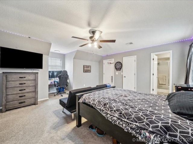 carpeted bedroom featuring ceiling fan and a textured ceiling