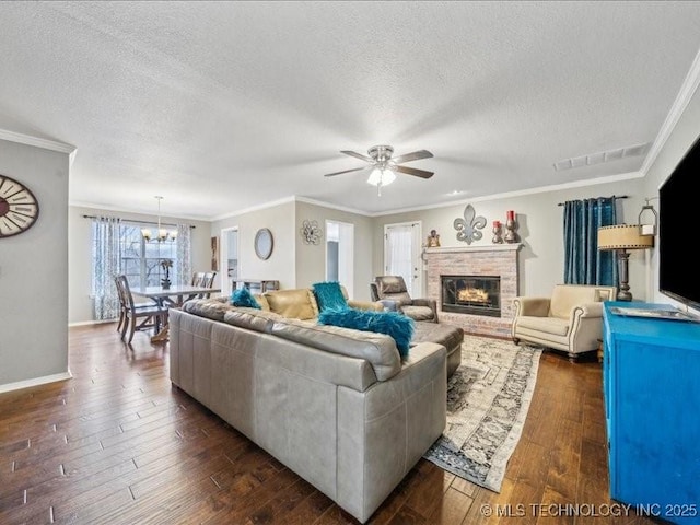 living room featuring dark hardwood / wood-style flooring, a brick fireplace, and ornamental molding