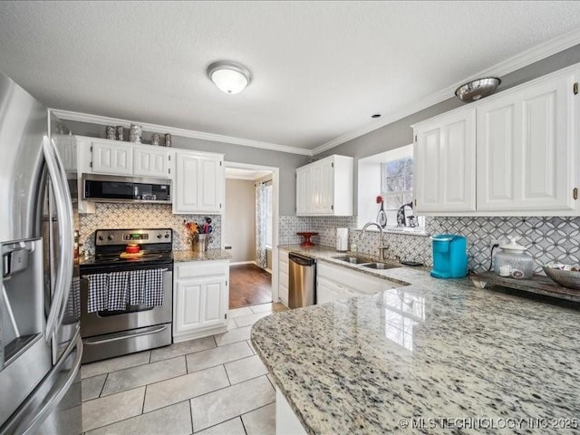 kitchen featuring sink, light tile patterned floors, appliances with stainless steel finishes, light stone countertops, and white cabinets