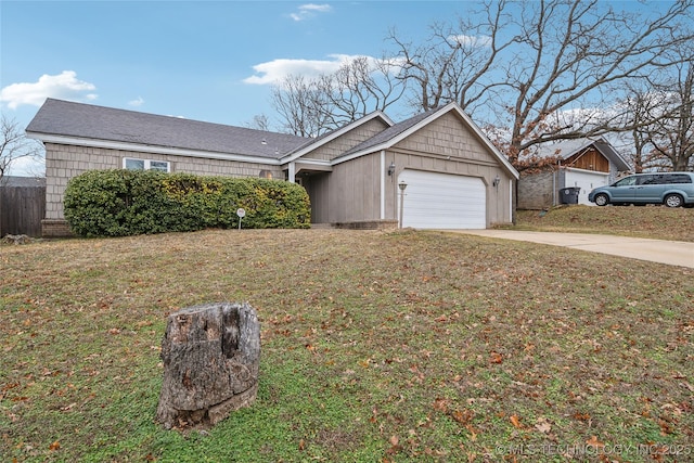 ranch-style house featuring a garage and a front yard