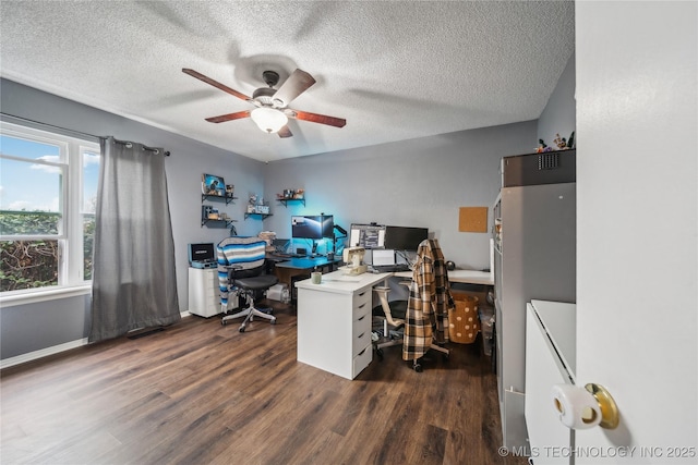 office space with a textured ceiling, dark wood-type flooring, and ceiling fan