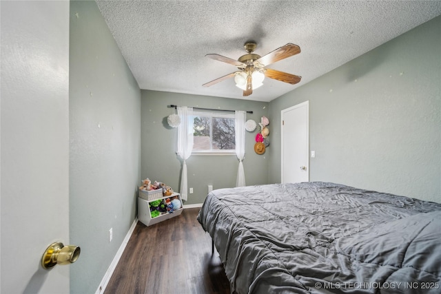 bedroom featuring ceiling fan, dark hardwood / wood-style flooring, and a textured ceiling