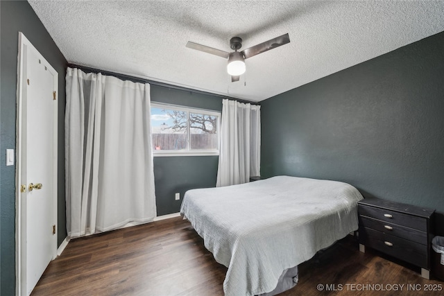 bedroom featuring ceiling fan, dark wood-type flooring, and a textured ceiling