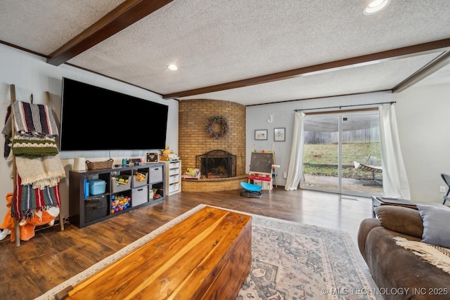 living room featuring beamed ceiling, wood-type flooring, and a textured ceiling