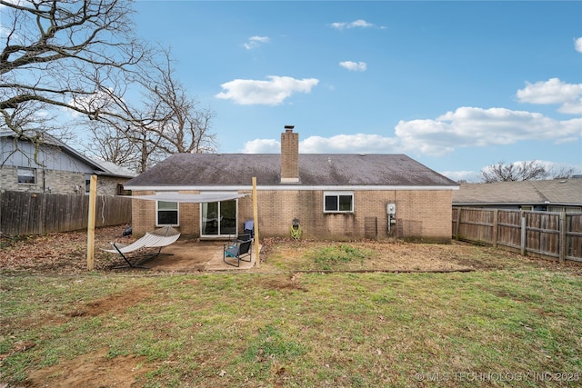 back of house featuring a patio and a lawn