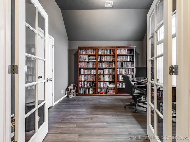 unfurnished office featuring french doors and lofted ceiling