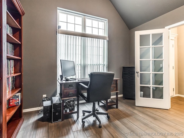 home office with hardwood / wood-style flooring and lofted ceiling