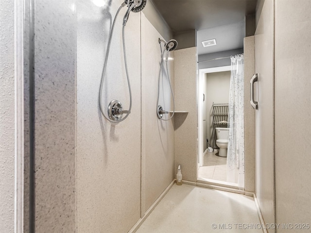 bathroom featuring toilet and walk in shower