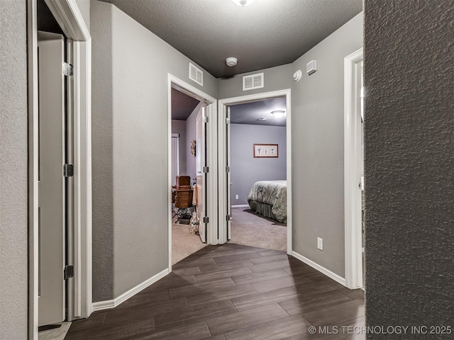 corridor with a textured ceiling