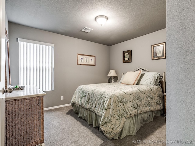 carpeted bedroom with a textured ceiling