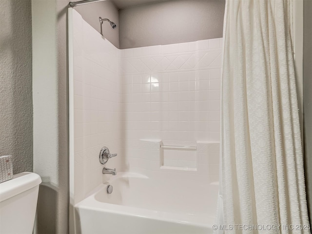 bathroom with toilet and shower / bath combo