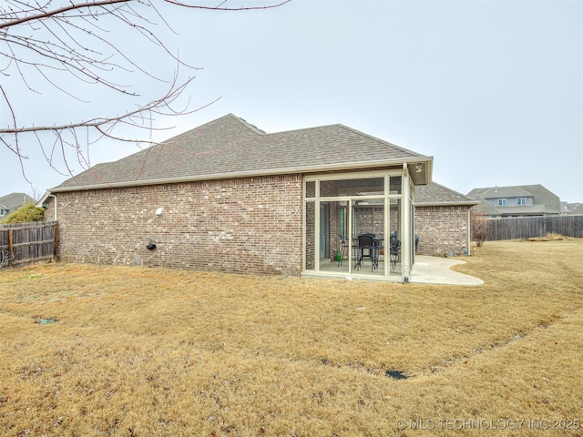 back of property with a patio and a lawn