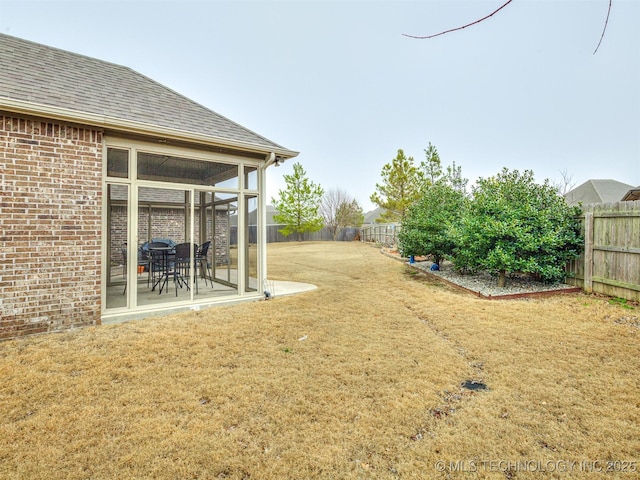 view of yard with a sunroom