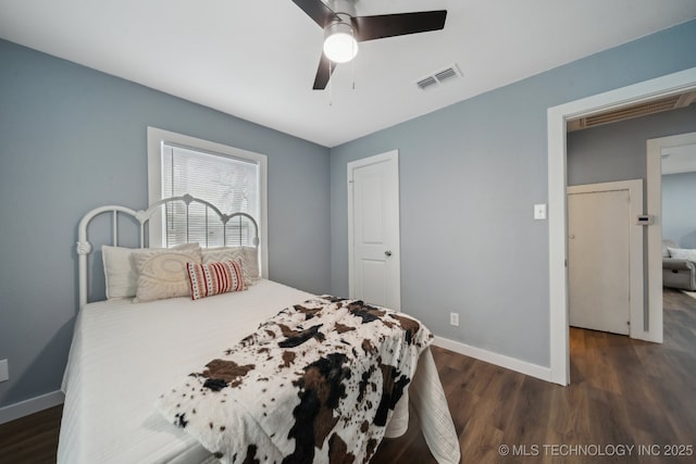 bedroom with ceiling fan and dark hardwood / wood-style floors