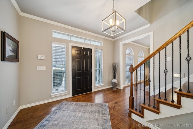 foyer featuring a healthy amount of sunlight, an inviting chandelier, and dark hardwood / wood-style floors