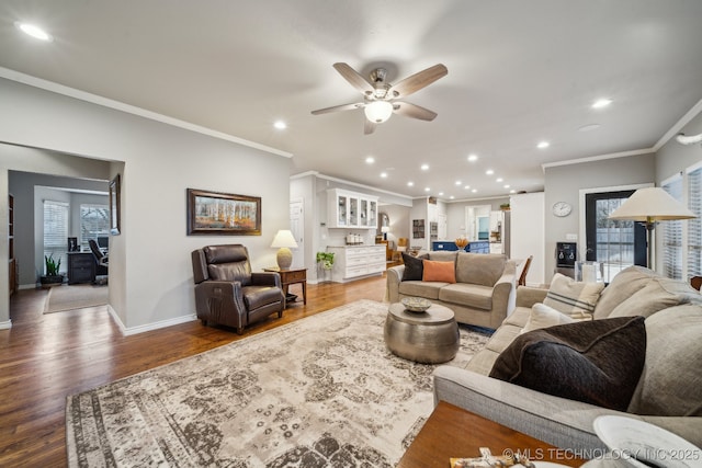 living room with wood-type flooring, a wealth of natural light, ceiling fan, and crown molding