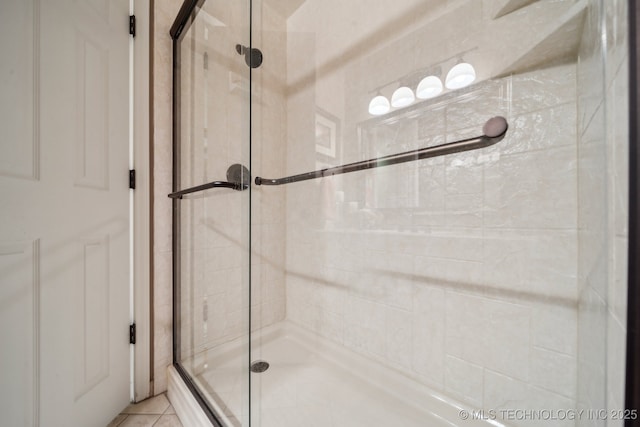 bathroom featuring tile patterned flooring and a shower with door