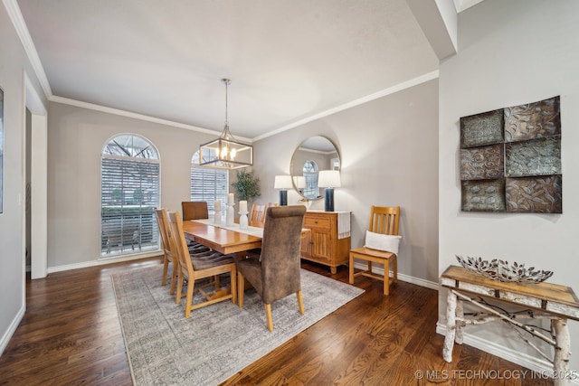 dining space with crown molding, dark hardwood / wood-style floors, and a chandelier