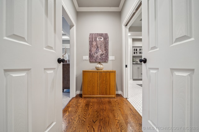 corridor with crown molding and dark hardwood / wood-style flooring