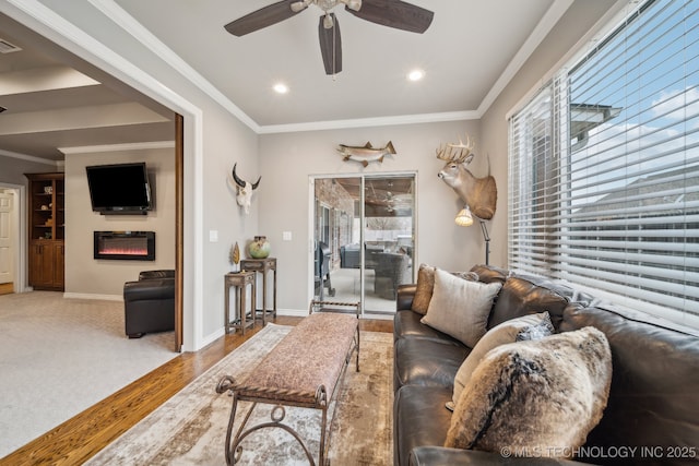 living room featuring hardwood / wood-style flooring, ceiling fan, and ornamental molding