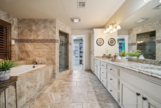 bathroom featuring vanity and separate shower and tub