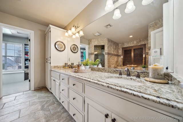 bathroom featuring vanity and a shower