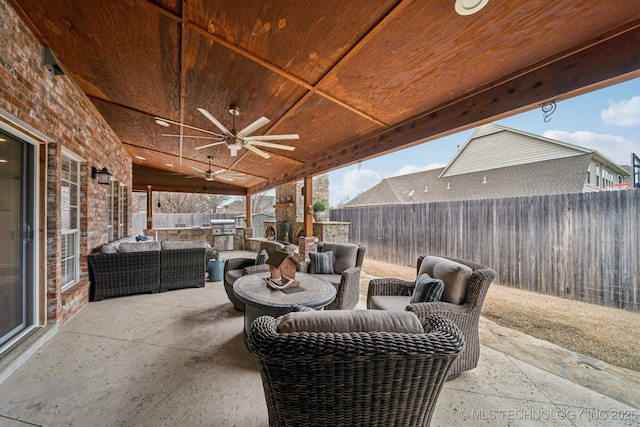 view of patio with an outdoor living space, exterior kitchen, grilling area, and ceiling fan