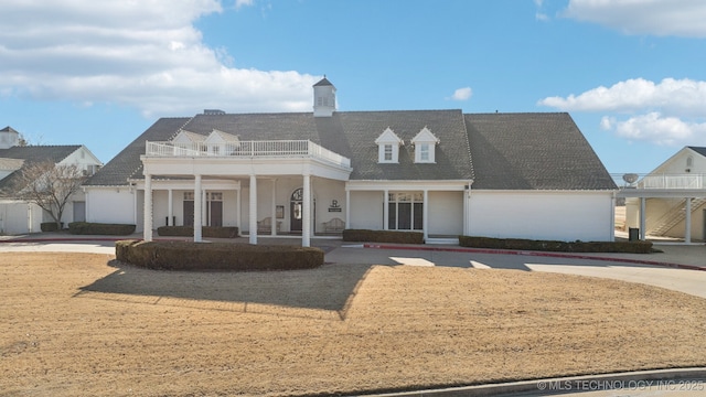 view of front of home with a balcony and covered porch