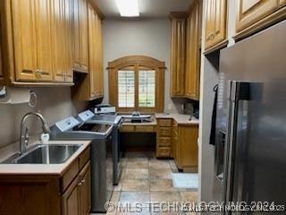 laundry room with separate washer and dryer and sink