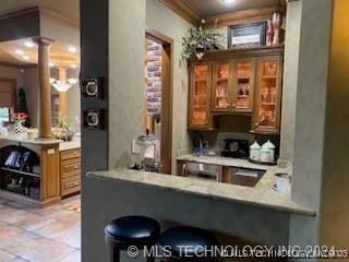 bar with ornate columns and crown molding