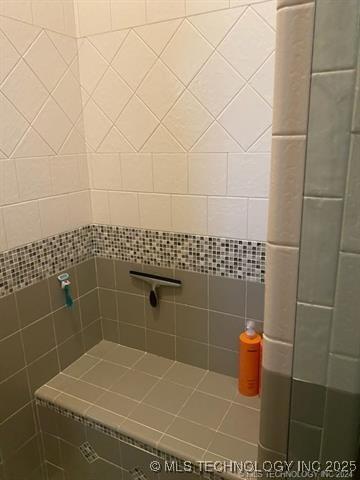 bathroom with a tile shower