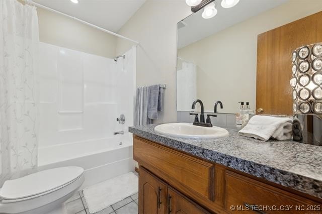 full bathroom featuring vanity, shower / bath combo, tile patterned floors, and toilet