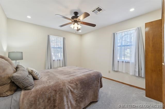 bedroom featuring light carpet and ceiling fan