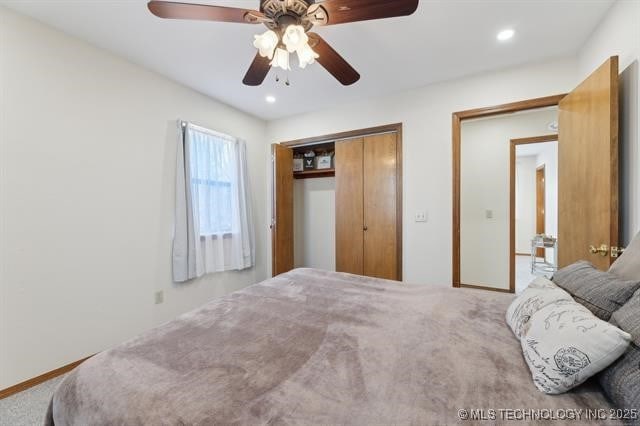 carpeted bedroom with a closet and ceiling fan