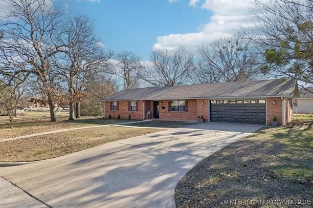 ranch-style home with a garage and a front yard