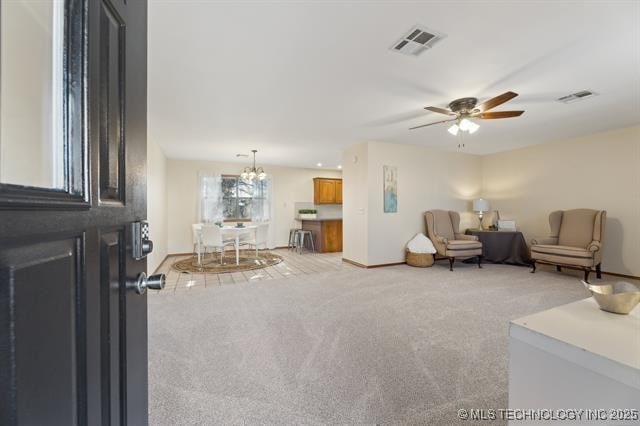 living room featuring light carpet and ceiling fan