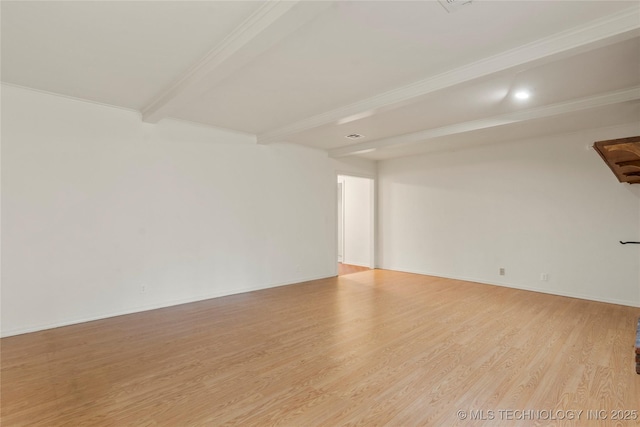 unfurnished room featuring beam ceiling and light wood-type flooring