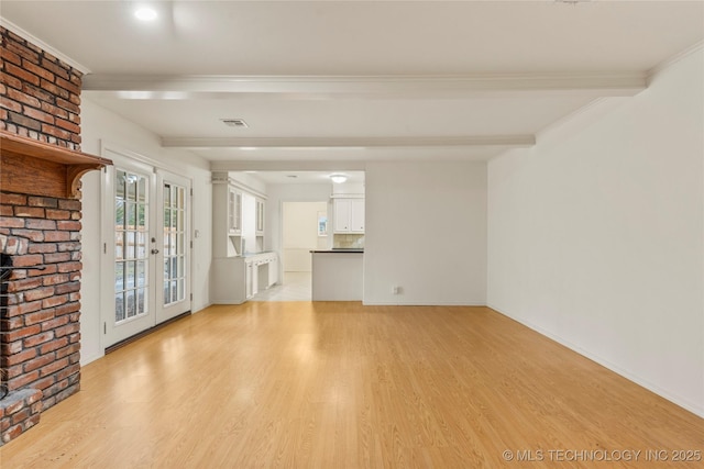 unfurnished living room with french doors, beam ceiling, crown molding, and light wood-type flooring