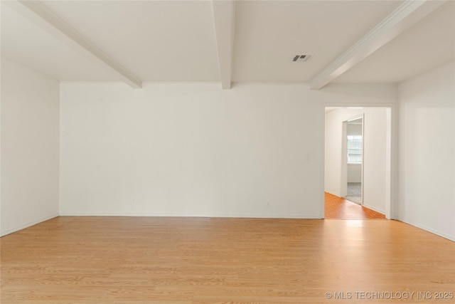 unfurnished room with beamed ceiling and light hardwood / wood-style floors