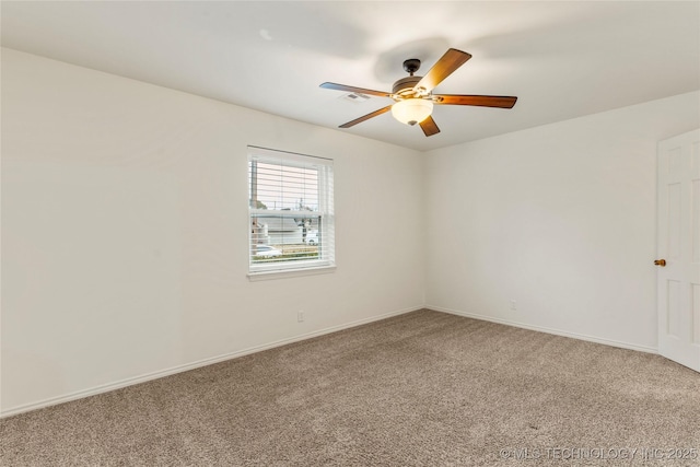 carpeted spare room featuring ceiling fan