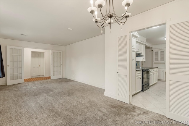 interior space with light carpet, a notable chandelier, and french doors