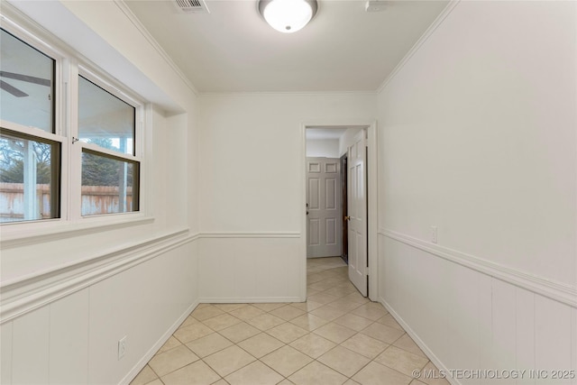 hall featuring ornamental molding and light tile patterned flooring